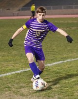 Lemoore Team Captain Christian Sanchez moves the ball in Tuesday's soccer loss to Lompoc in Tiger Stadium.
